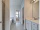 Bathroom featuring modern fixtures, tiled floor, standalone tub, and ample cabinet space at 173 Haverling Pass, Hampton, GA 30228