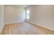 Neutral bedroom with light hardwood flooring, window, and ample space at 173 Haverling Pass, Hampton, GA 30228