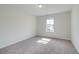 Neutral bedroom with carpet, a window bringing in natural light, and crisp white walls at 173 Haverling Pass, Hampton, GA 30228