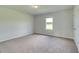 Bedroom with neutral carpet, natural light from the window, and white walls at 173 Haverling Pass, Hampton, GA 30228