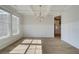 Bright dining room with wainscoting, coffered ceiling, wood floors and large windows for natural light at 173 Haverling Pass, Hampton, GA 30228