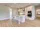 Modern kitchen with stainless steel appliances, island with pendant lighting, and light hardwood floors at 173 Haverling Pass, Hampton, GA 30228