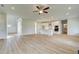 Spacious open-concept living room with modern kitchen featuring stainless steel appliances and light hardwood floors at 173 Haverling Pass, Hampton, GA 30228