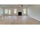 Spacious living room with fireplace, wood flooring, recessed lighting, and backyard views at 173 Haverling Pass, Hampton, GA 30228