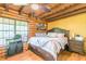 Charming bedroom with a king-size bed and log cabin walls at 58 Wesley Chapel Ln, Villa Rica, GA 30180