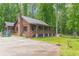 Charming log cabin home nestled on a spacious lot with mature trees at 58 Wesley Chapel Ln, Villa Rica, GA 30180