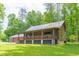 Rustic log cabin with a wraparound porch and a large yard at 58 Wesley Chapel Ln, Villa Rica, GA 30180