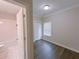 Inviting bedroom with dark wood floors adjacent to bathroom with tile at 2005 Ocean Nw Dr, Atlanta, GA 30318
