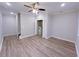 Neutral living area featuring modern ceiling fan, trim detail, and durable hardwood-style floors at 2005 Ocean Nw Dr, Atlanta, GA 30318