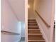 A view of the staircase featuring wood stairs, white risers, and handrails on both sides at 2005 Ocean Nw Dr, Atlanta, GA 30318