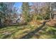 Large backyard with grassy area and a wooden fence at 1225 W Wesley Nw Rd, Atlanta, GA 30327