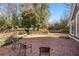 Brick patio backyard with wooden chairs and lush greenery at 1225 W Wesley Nw Rd, Atlanta, GA 30327