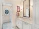 Bathroom with marble vanity, oval window, and tiled floor at 1225 W Wesley Nw Rd, Atlanta, GA 30327