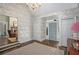 Bright entryway with hardwood floors, decorative wallpaper, and view of living room at 1225 W Wesley Nw Rd, Atlanta, GA 30327