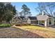 Exterior view of a house with gray siding and a large yard at 1225 W Wesley Nw Rd, Atlanta, GA 30327