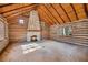 Spacious living room with a large stone fireplace in a log cabin at 1225 W Wesley Nw Rd, Atlanta, GA 30327