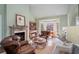 Cozy living room with fireplace, leather armchairs, and large windows at 1225 W Wesley Nw Rd, Atlanta, GA 30327