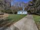 Blue house with driveway and wooded area at 2538 Gordon Se Cir, Smyrna, GA 30080