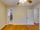 Bedroom with hardwood floors and access to bathroom at 4685 Ruby Ln, Forest Park, GA 30297