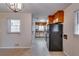 View of galley kitchen, dining area and black refrigerator at 4685 Ruby Ln, Forest Park, GA 30297