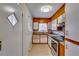 Galley kitchen with wood cabinets and granite counters at 4685 Ruby Ln, Forest Park, GA 30297