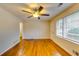 Hardwood floors and ceiling fan in bright living room at 4685 Ruby Ln, Forest Park, GA 30297