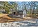 Wide angle view of a split-level home showcasing a driveway, garage, and landscaped yard with mature trees at 2360 S Hairston Rd, Decatur, GA 30035