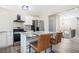 Modern kitchen featuring stainless steel appliances, granite countertops, a kitchen island, and stylish barstools at 2360 S Hairston Rd, Decatur, GA 30035