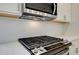 Close-up of gas cooktop and white hexagonal backsplash at 200 Dahlia Dr, Woodstock, GA 30188