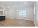 Bright dining area with wood floors, modern lighting fixture, and a large window at 913 Agate Ln, Lawrenceville, GA 30043