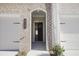 Welcoming front entrance with brick archway, house number, and adjacent garage doors at 913 Agate Ln, Lawrenceville, GA 30043