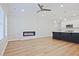 Open-concept living room featuring a modern fireplace, ceiling fan and sleek kitchen with large island at 913 Agate Ln, Lawrenceville, GA 30043