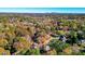 Aerial view of home nestled among mature trees with beautiful Fall foliage at 4511 Balmoral Nw Rd, Kennesaw, GA 30144