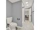 Bathroom with toilet, walk-in shower and grey walls features modern fixtures and design at 4511 Balmoral Nw Rd, Kennesaw, GA 30144