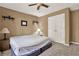 Bedroom with double door closet, ceiling fan, carpet, and neutral paint at 4511 Balmoral Nw Rd, Kennesaw, GA 30144