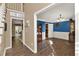 Elegant dining room with blue accent wall, wainscoting, wood floors, and access to other rooms at 4511 Balmoral Nw Rd, Kennesaw, GA 30144