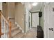 Inviting hallway with carpeted stairs, tile flooring, and neutral paint palette offers warmth and elegance at 4511 Balmoral Nw Rd, Kennesaw, GA 30144