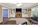 Inviting living room featuring a stone fireplace, built-in shelves, and abundant natural light at 4511 Balmoral Nw Rd, Kennesaw, GA 30144