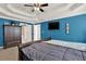 Inviting bedroom featuring blue walls, a flat screen tv, and a large dresser at 4511 Balmoral Nw Rd, Kennesaw, GA 30144