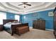 Spacious bedroom with a coffered ceiling, blue walls, and rich dark wood furniture at 4511 Balmoral Nw Rd, Kennesaw, GA 30144