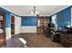 Well-lit office featuring blue walls, wainscoting, dark wood furniture, and wood floors at 4511 Balmoral Nw Rd, Kennesaw, GA 30144