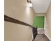 A downward view of a carpeted staircase with a wooden handrail at 4511 Balmoral Nw Rd, Kennesaw, GA 30144