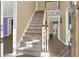 Inviting staircase with carpeted steps and a wooden handrail, connecting the entryway to the upper level at 4511 Balmoral Nw Rd, Kennesaw, GA 30144