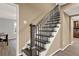 Carpeted staircase with decorative wrought iron spindles and a wooden handrail at 4511 Balmoral Nw Rd, Kennesaw, GA 30144