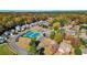 Aerial view of two blue tennis courts surrounded by community homes and fall foliage at 4511 Balmoral Nw Rd, Kennesaw, GA 30144