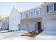 Charming townhome showcasing a brick and gray color scheme, complete with an attached one car garage at 905 Agate Ln, Lawrenceville, GA 30043