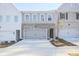 Inviting townhome with a light gray color scheme, featuring a one-car garage and modern design elements at 905 Agate Ln, Lawrenceville, GA 30043