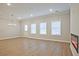 Contemporary living space with a decorative fireplace, chandelier, and multiple windows offering natural light at 905 Agate Ln, Lawrenceville, GA 30043