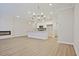 Spacious living area with a kitchen island, fireplace, recessed lighting, and modern vinyl plank flooring at 905 Agate Ln, Lawrenceville, GA 30043