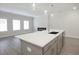 Bright kitchen featuring gray kitchen island with white countertop, perfect for entertaining and meal preparation at 909 Agate Ln, Lawrenceville, GA 30043